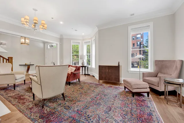 a living room with furniture and a chandelier