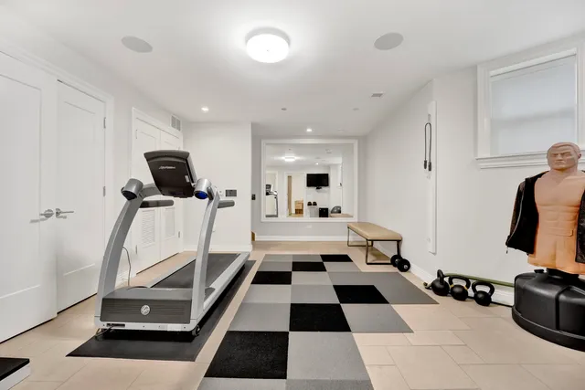 a room with gym equipment and a flat screen tv