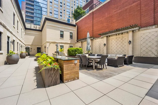 a view of a patio with couches and potted plants