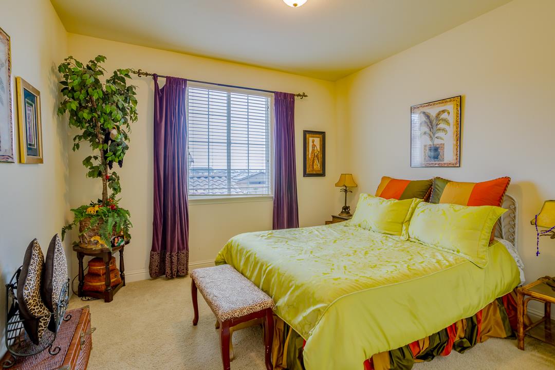 a bedroom with a bed and a potted plant