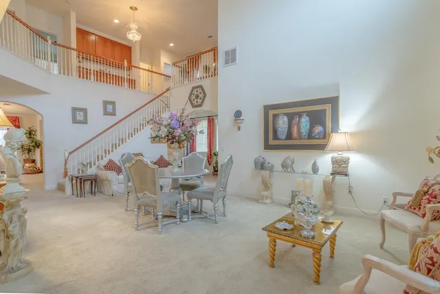 a living room with furniture and stairs