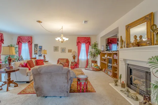 a living room with lots of furniture and a fireplace