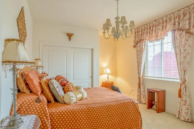 a bedroom with a bed and a potted plant