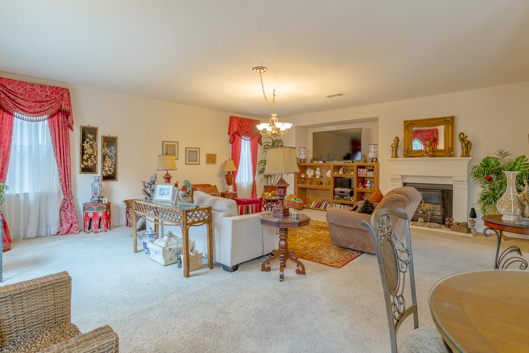 2563 Riviera Court Tulare, CA 93274 - Photo 17 of 31 a living room with furniture and a fireplace