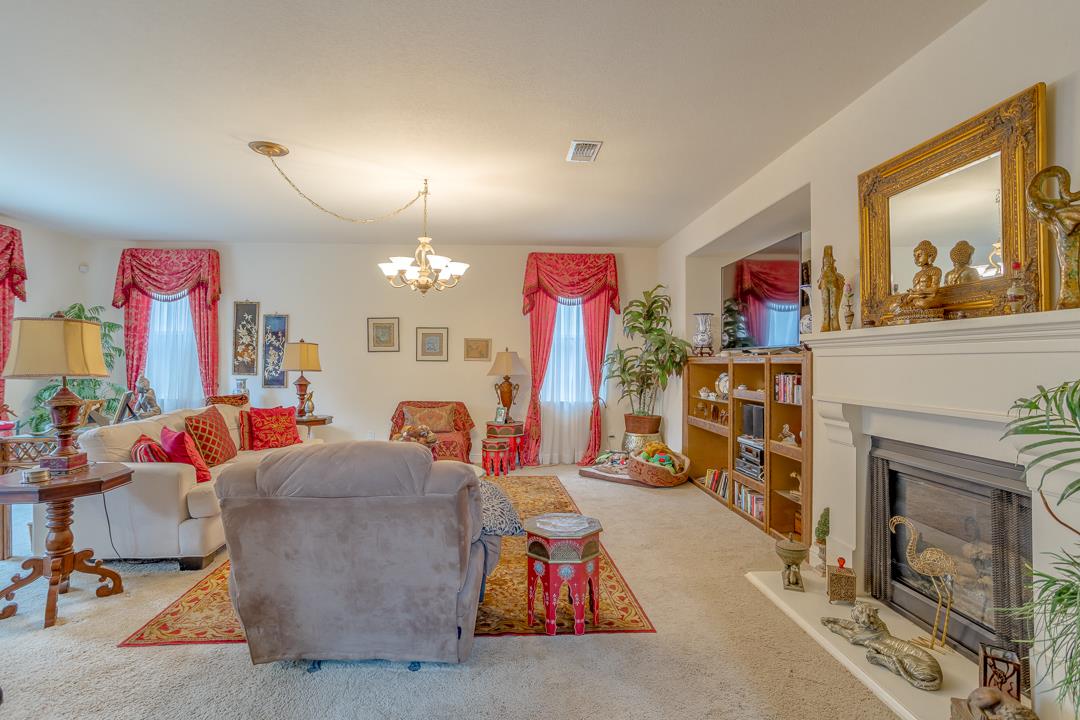2563 Riviera Court Tulare, CA 93274 - Photo 18 of 31 a living room with lots of furniture and a fireplace