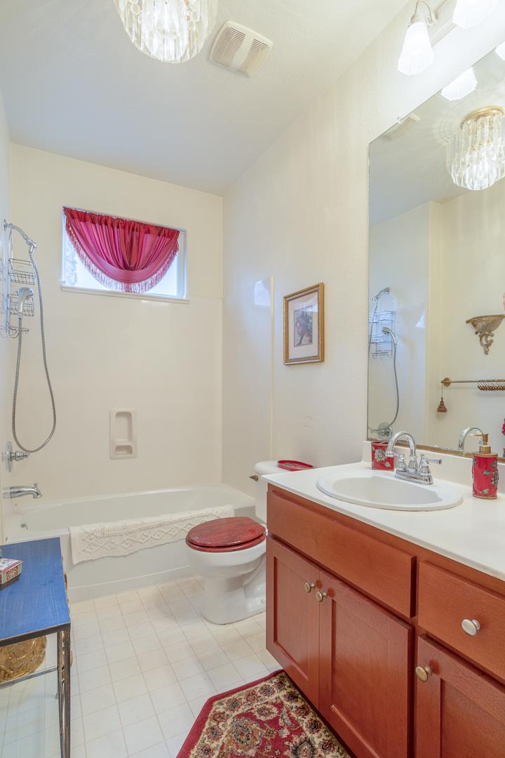 2563 Riviera Court Tulare, CA 93274 - Photo 29 of 31 a bathroom with a sink mirror vanity and toilet