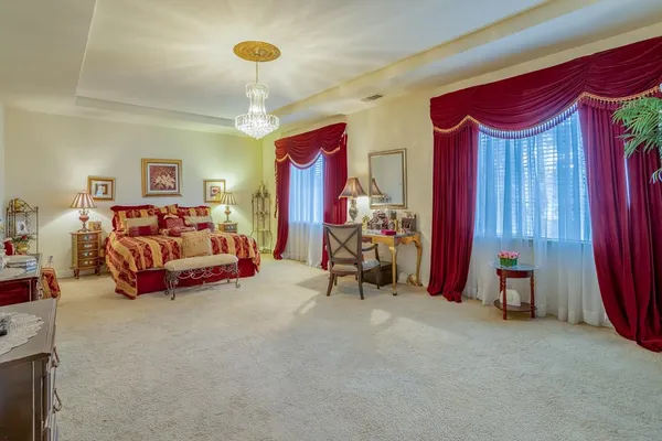 a bedroom with furniture and a chandelier