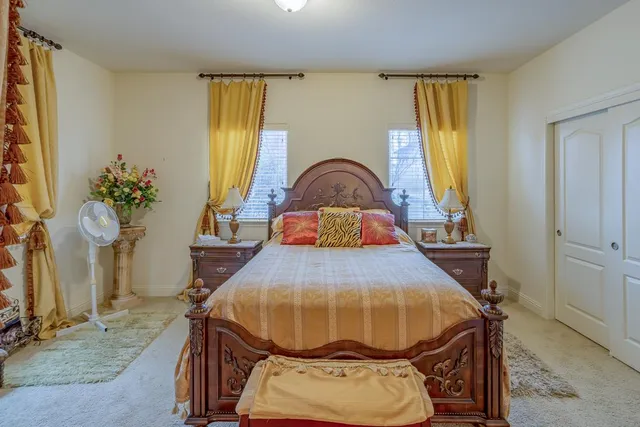 a bed sitting in a bedroom next to a window