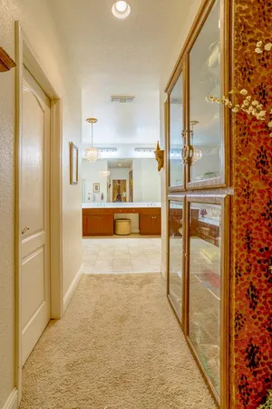 a view of a hallway with a refrigerator