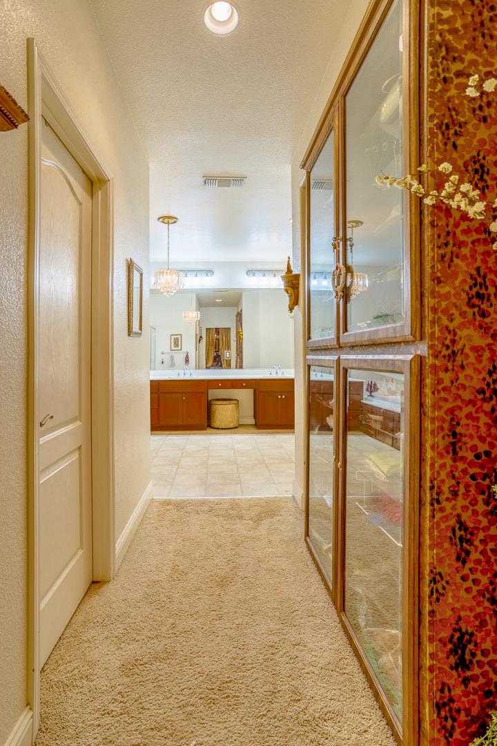 2563 Riviera Court Tulare, CA 93274 - Photo 4 of 31 a view of a hallway with a refrigerator