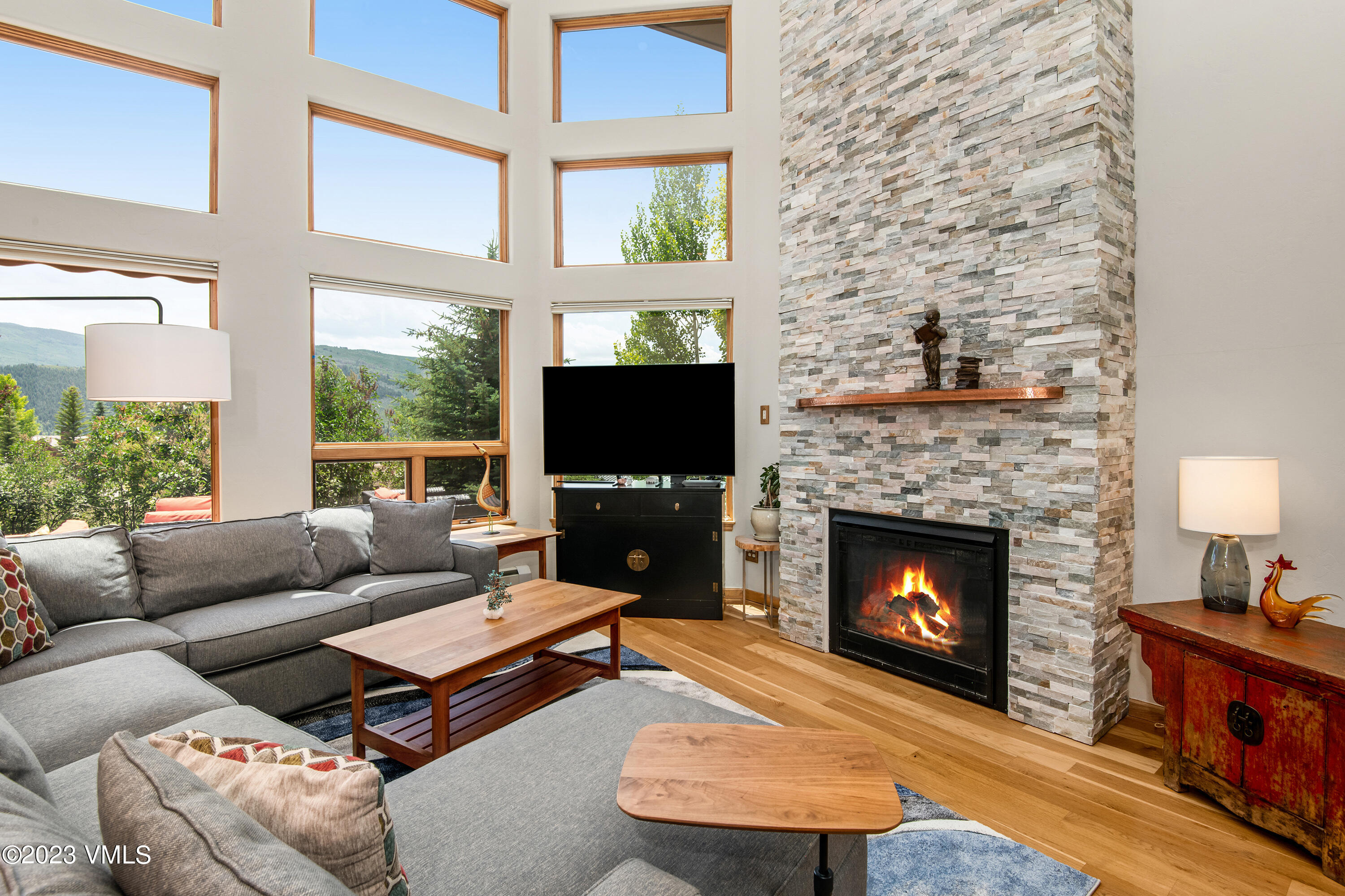 1471 Singletree Road Edwards, CO 81632 - Photo 11 of 47 a living room with furniture a flat screen tv and a fireplace