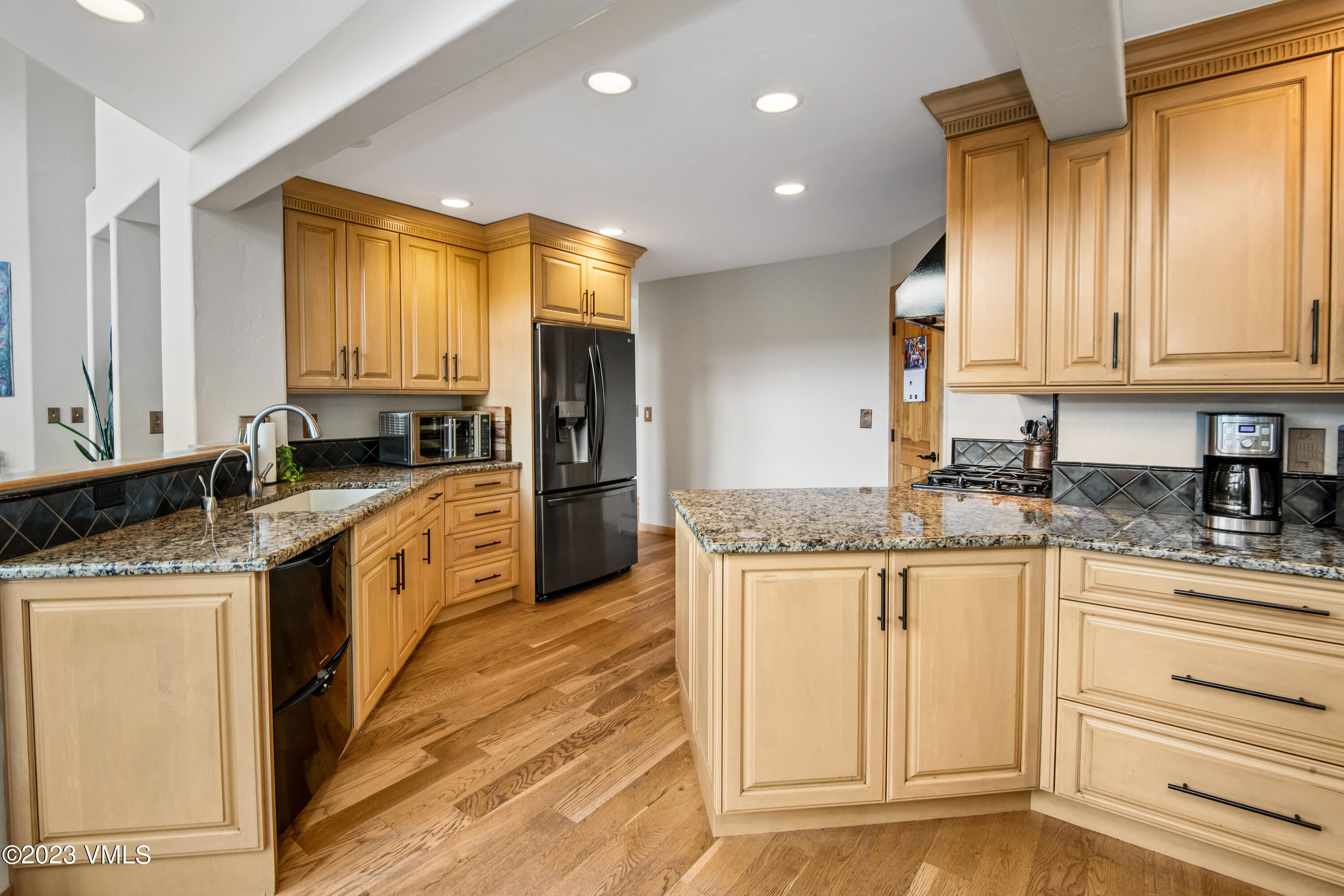 1471 Singletree Road Edwards, CO 81632 - Photo 14 of 47 a kitchen with stainless steel appliances granite countertop a stove a sink and a refrigerator