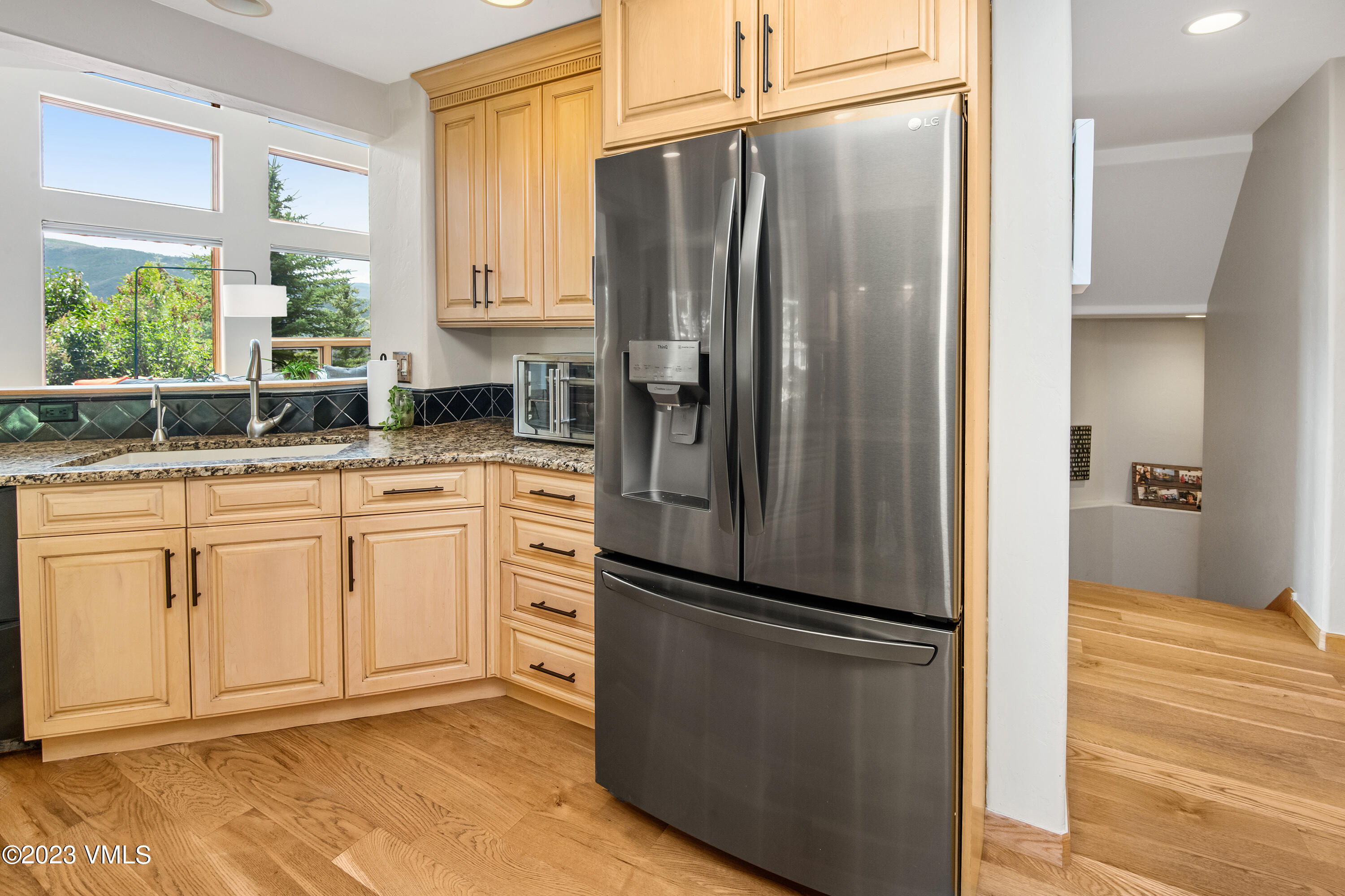 1471 Singletree Road Edwards, CO 81632 - Photo 15 of 47 a kitchen with granite countertop a refrigerator and a sink