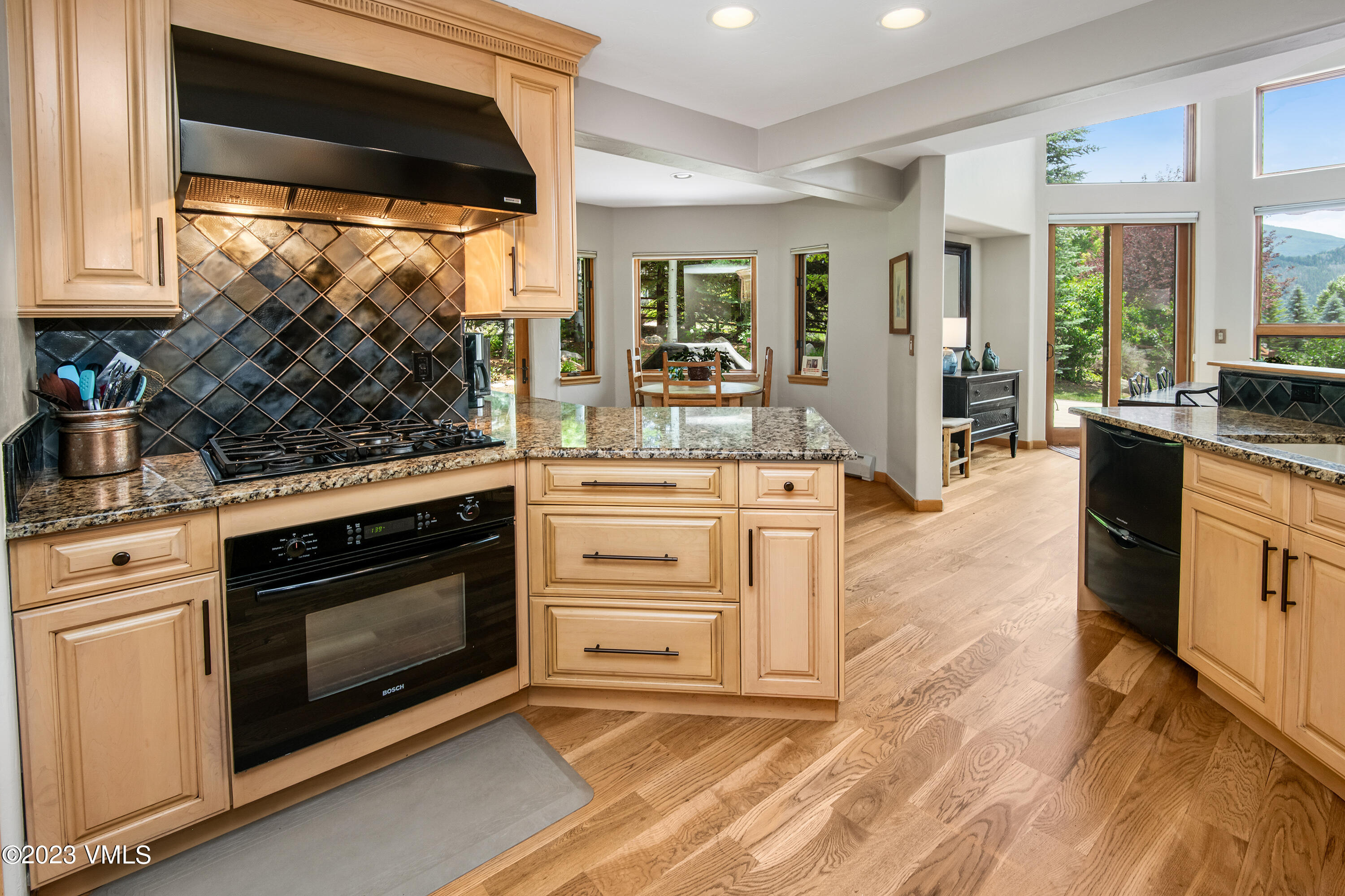 1471 Singletree Road Edwards, CO 81632 - Photo 16 of 47 a kitchen with stainless steel appliances white cabinets and a fireplace