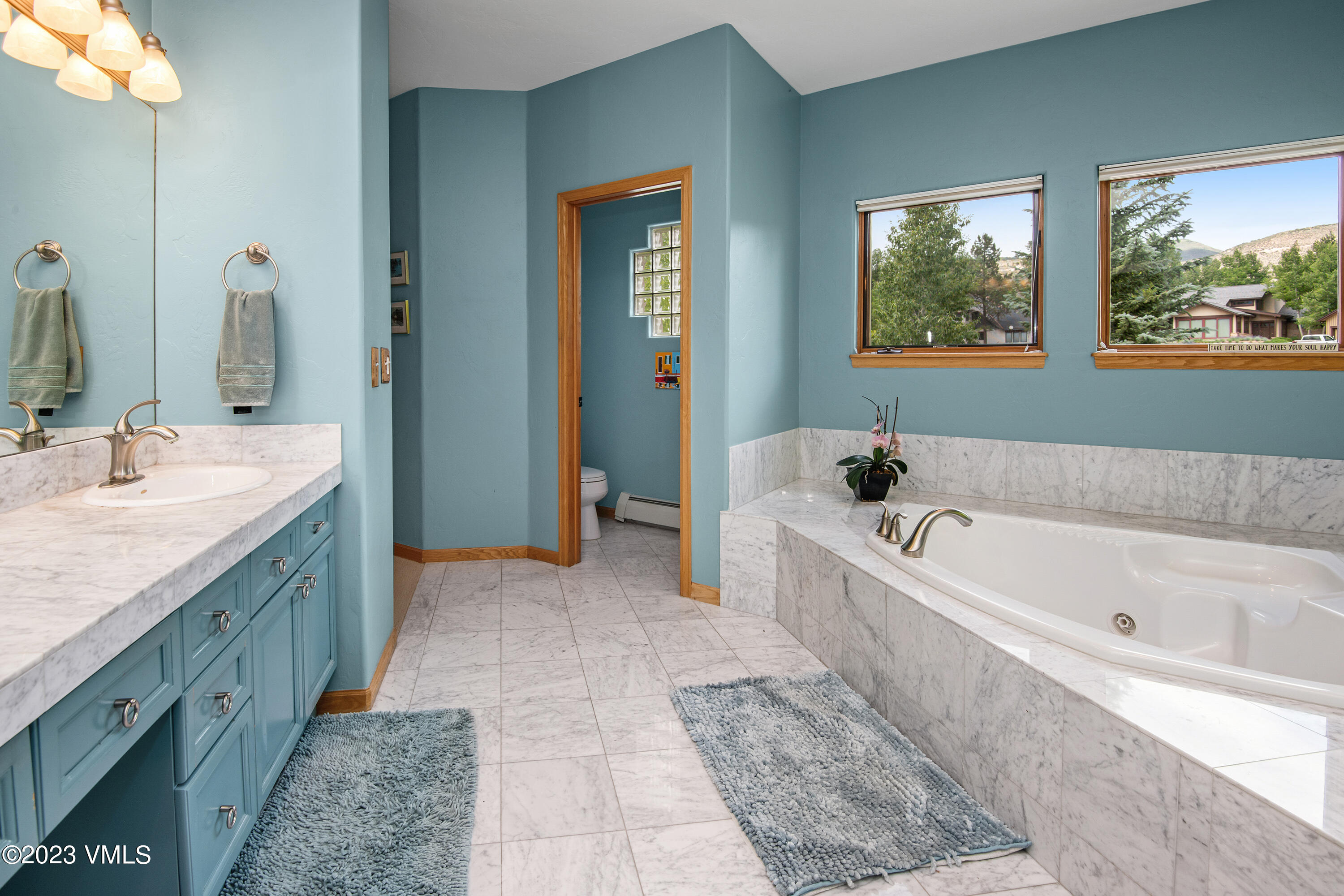1471 Singletree Road Edwards, CO 81632 - Photo 20 of 47 a bathroom with a tub a double vanity sink and mirror