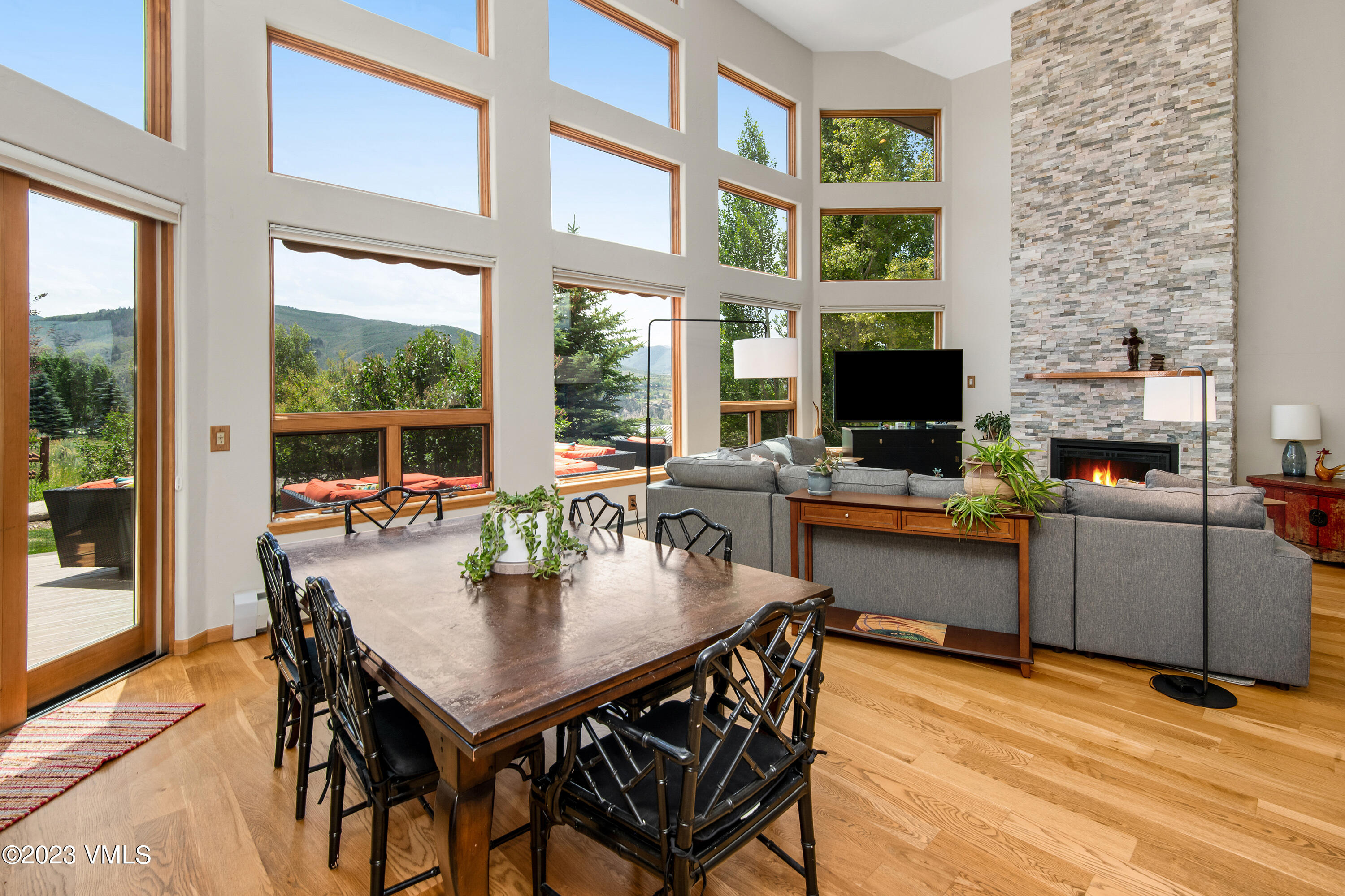 1471 Singletree Road Edwards, CO 81632 - Photo 10 of 47 a dining room with furniture a floor to ceiling window and potted plants