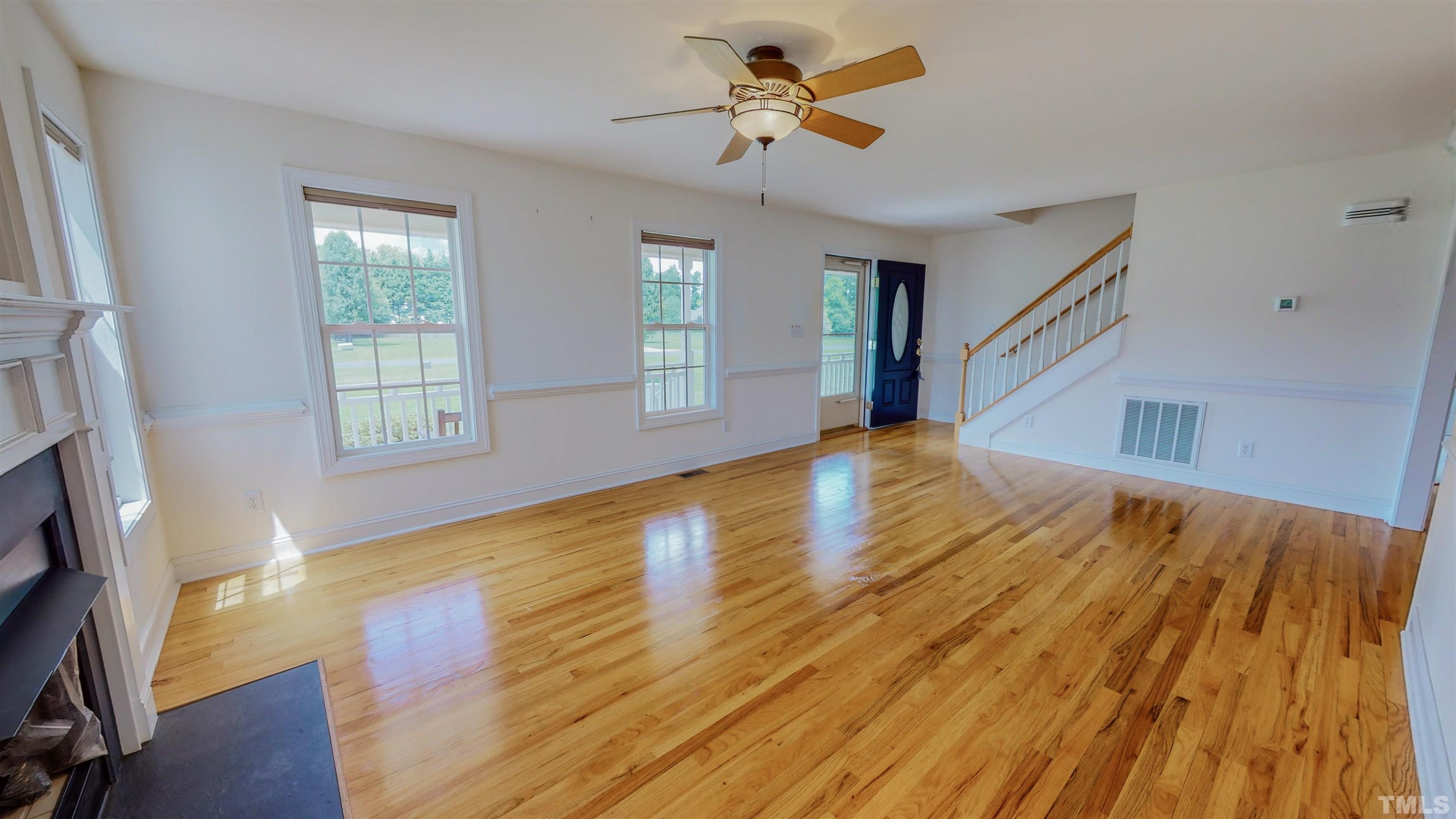 151 Fletcher Ridge Road Timberlake, NC 27583 - Photo 3 of 49 a view of empty room with wooden floor and fan