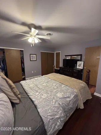 a bedroom with a large bed and a chandelier