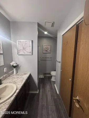 a bathroom with a granite countertop sink toilet and shower