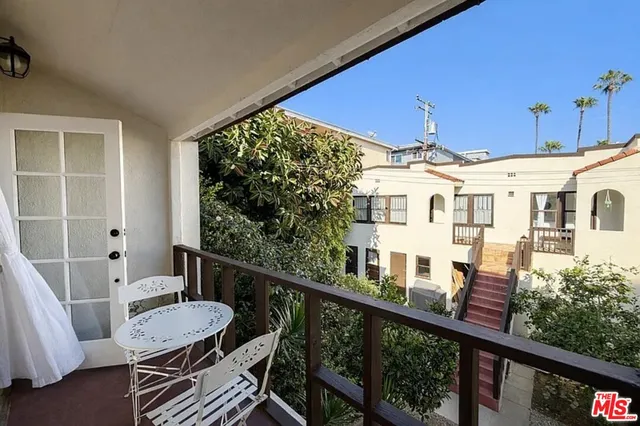 a view of a balcony with chairs