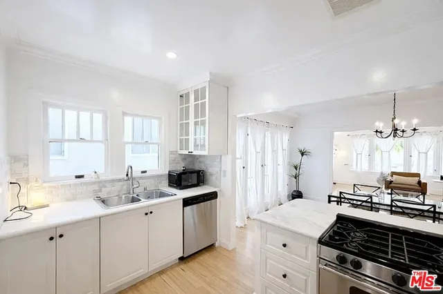 a kitchen with a sink stove and cabinets
