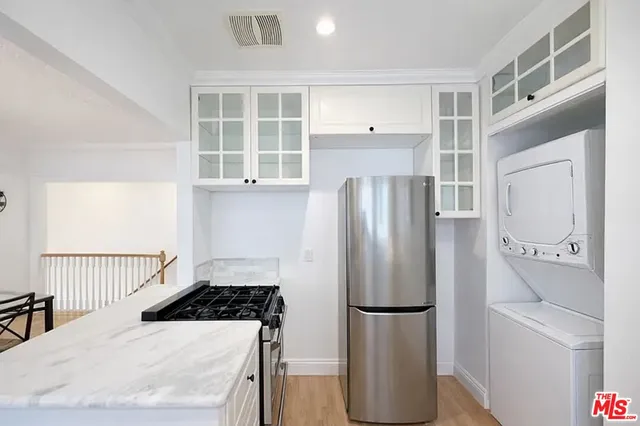 a kitchen with a refrigerator and a sink