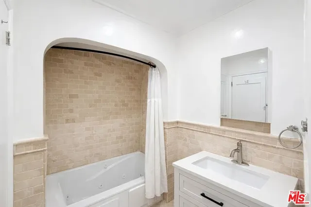 a bathroom with a bathtub and a sink