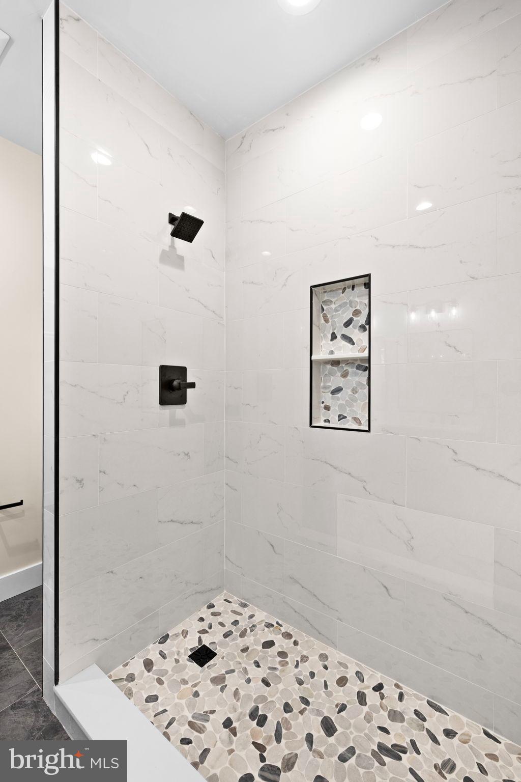 312 9th Street Colonial Beach, VA 22443 - Photo 22 of 62 Sleek modern shower with elegant stone accents.