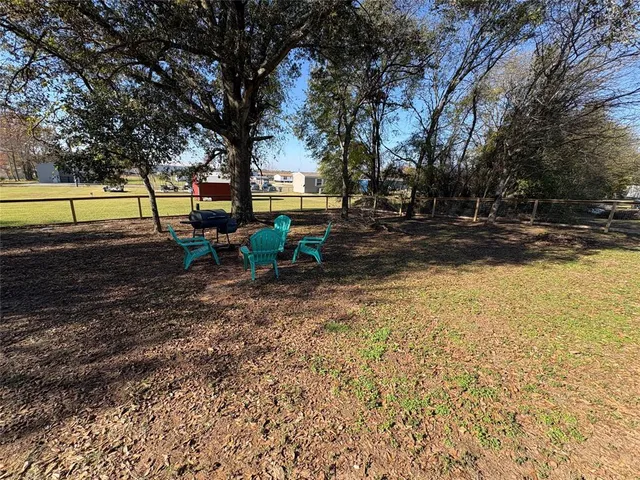a view of backyard with swimming pool