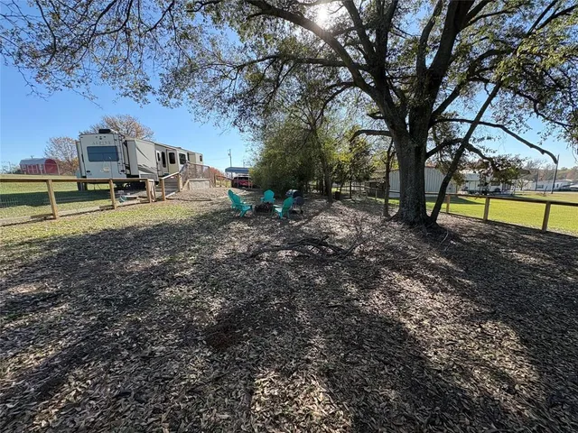 a view of a backyard with trees