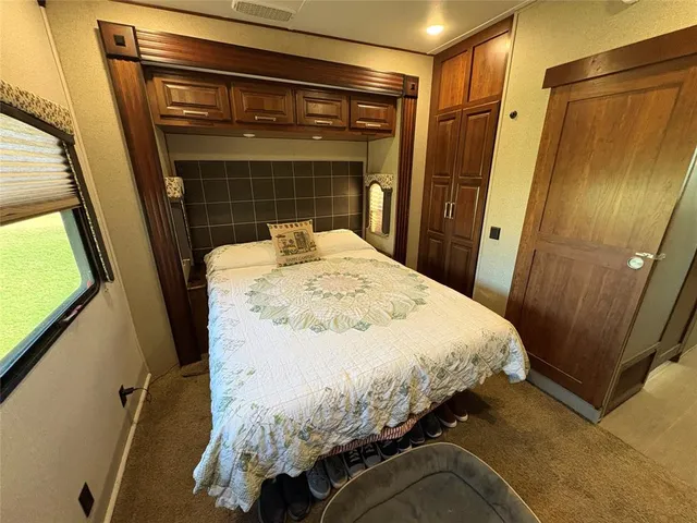 a bedroom with a bed and a mirror