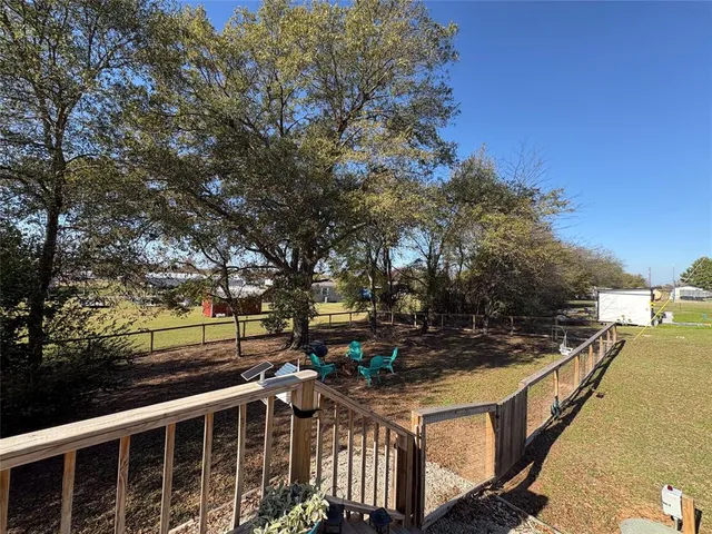 a view of a wooden deck and trees