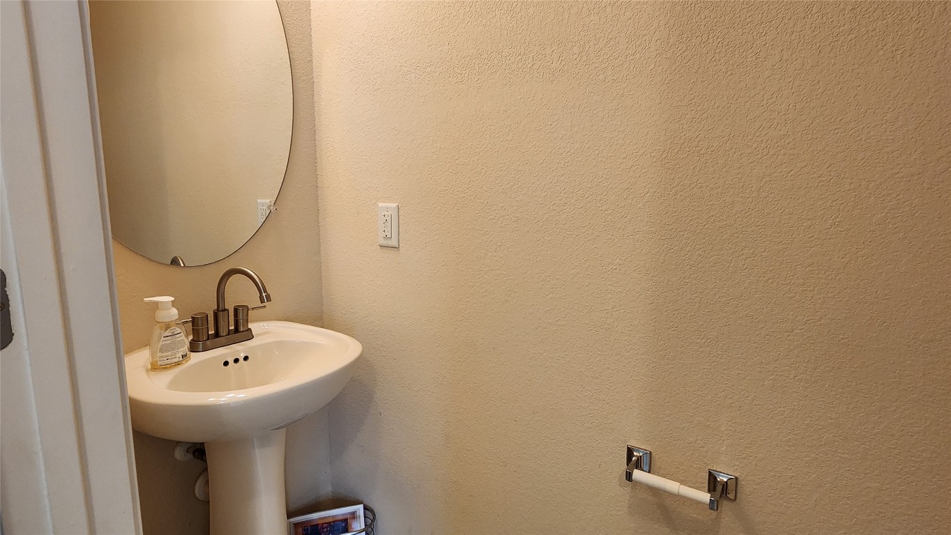 5432 Juniper Jct Lane Austin, TX 78744 - Photo 11 of 26 a bathroom with a sink and a mirror