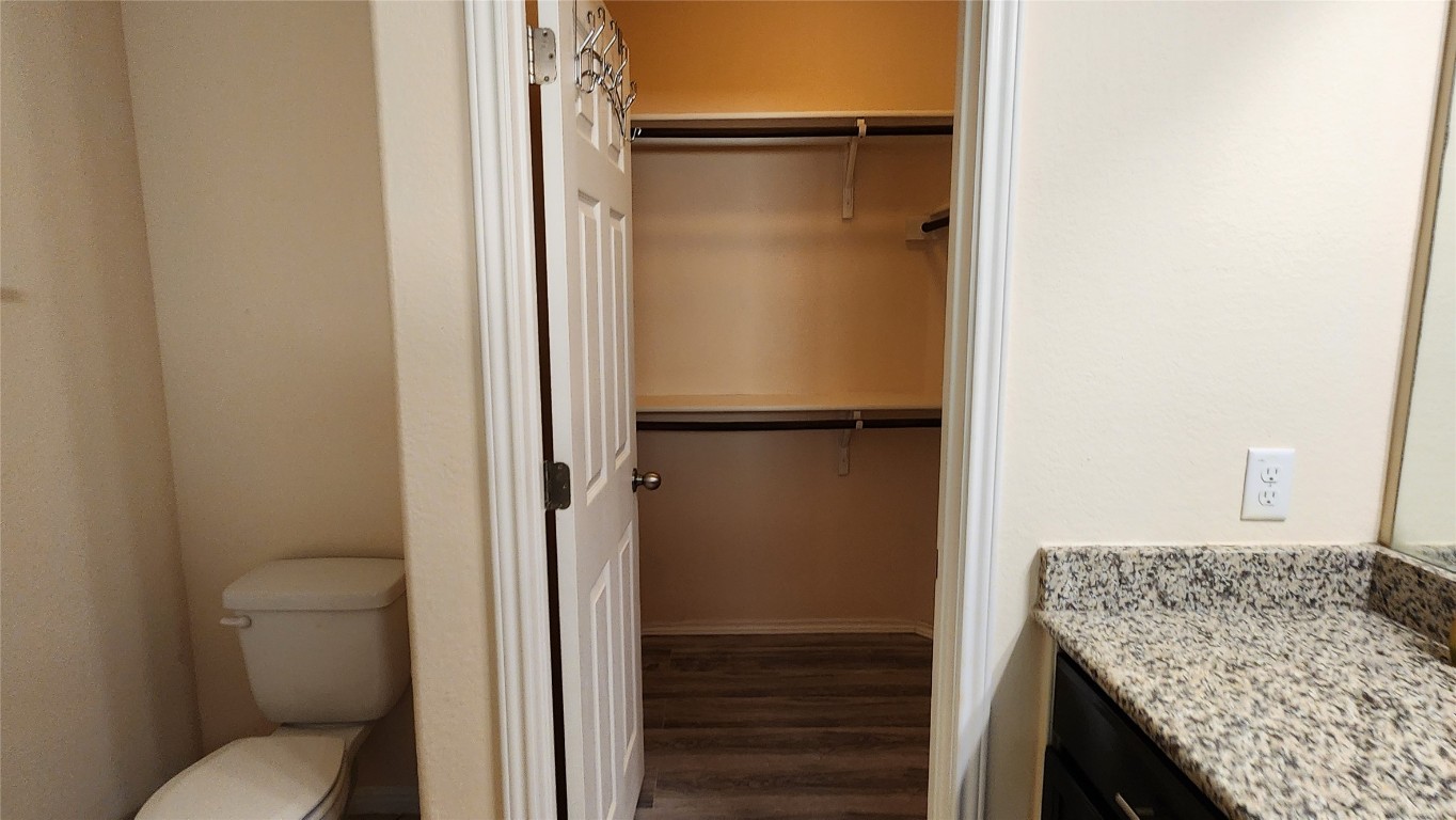 5432 Juniper Jct Lane Austin, TX 78744 - Photo 17 of 26 a bathroom with a granite countertop sink toilet and shower