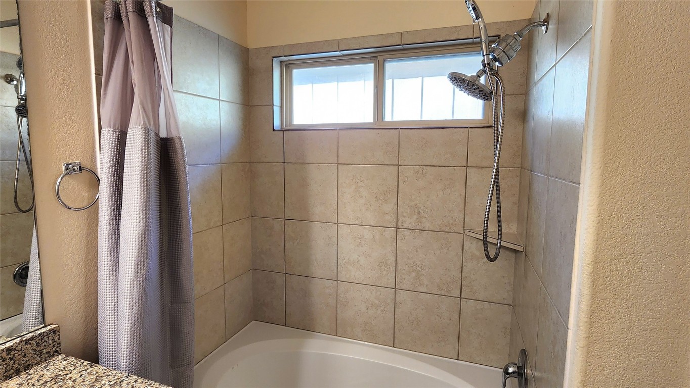 5432 Juniper Jct Lane Austin, TX 78744 - Photo 19 of 26 a bathroom with a bathtub and shower