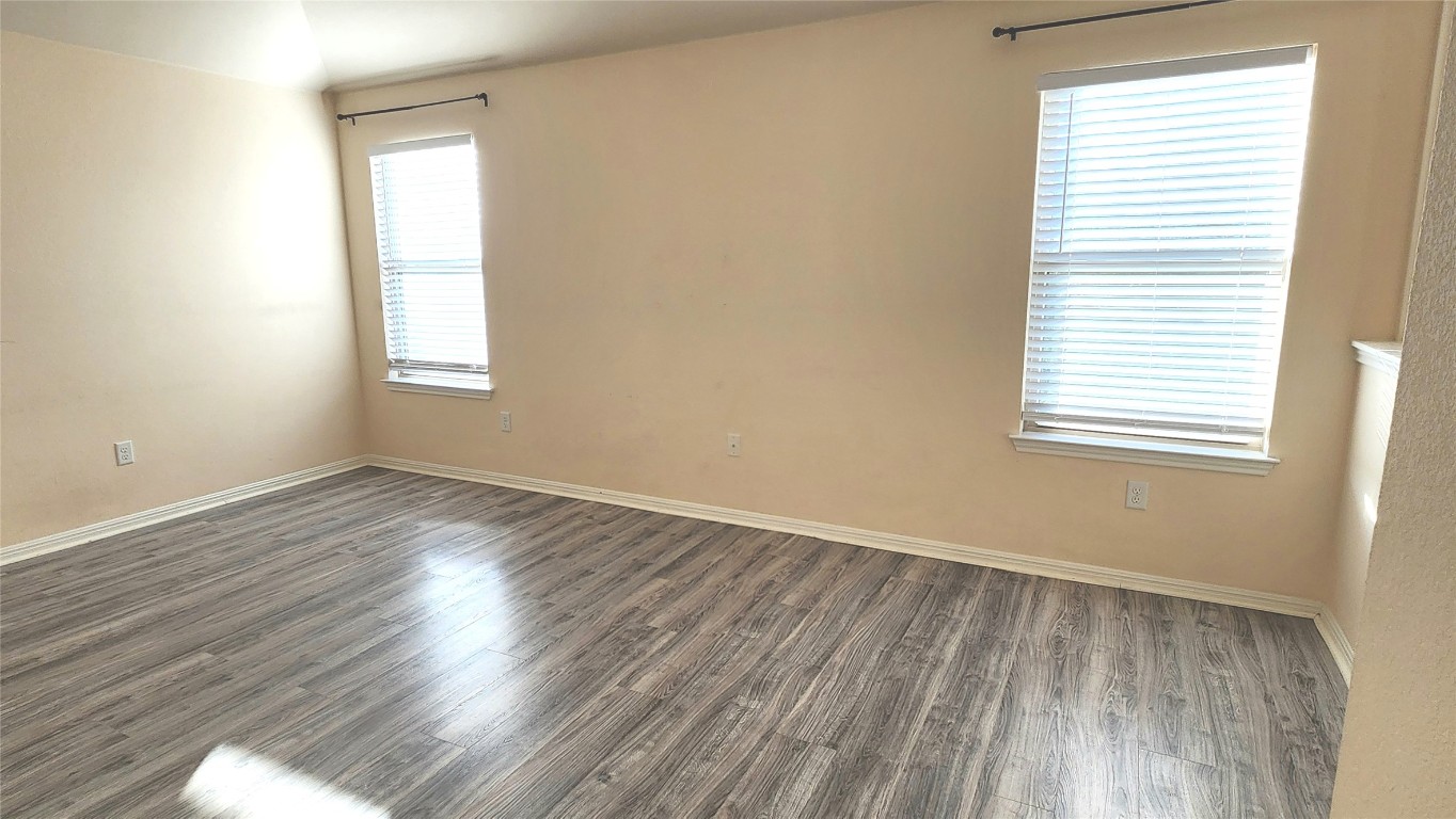 5432 Juniper Jct Lane Austin, TX 78744 - Photo 23 of 26 an empty room with wooden floor and windows