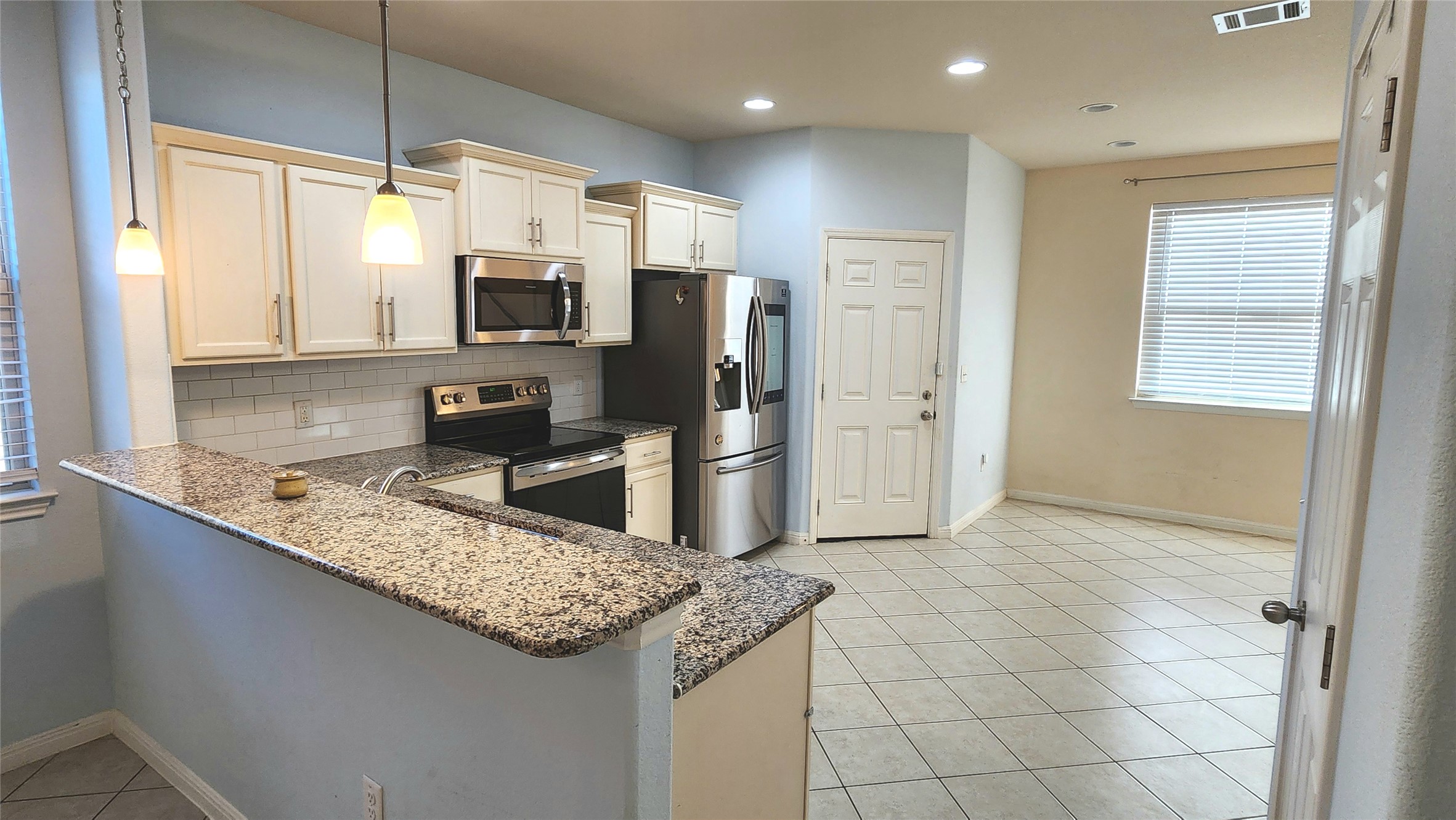 5432 Juniper Jct Lane Austin, TX 78744 - Photo 8 of 26 a kitchen with stainless steel appliances granite countertop a sink and a stove