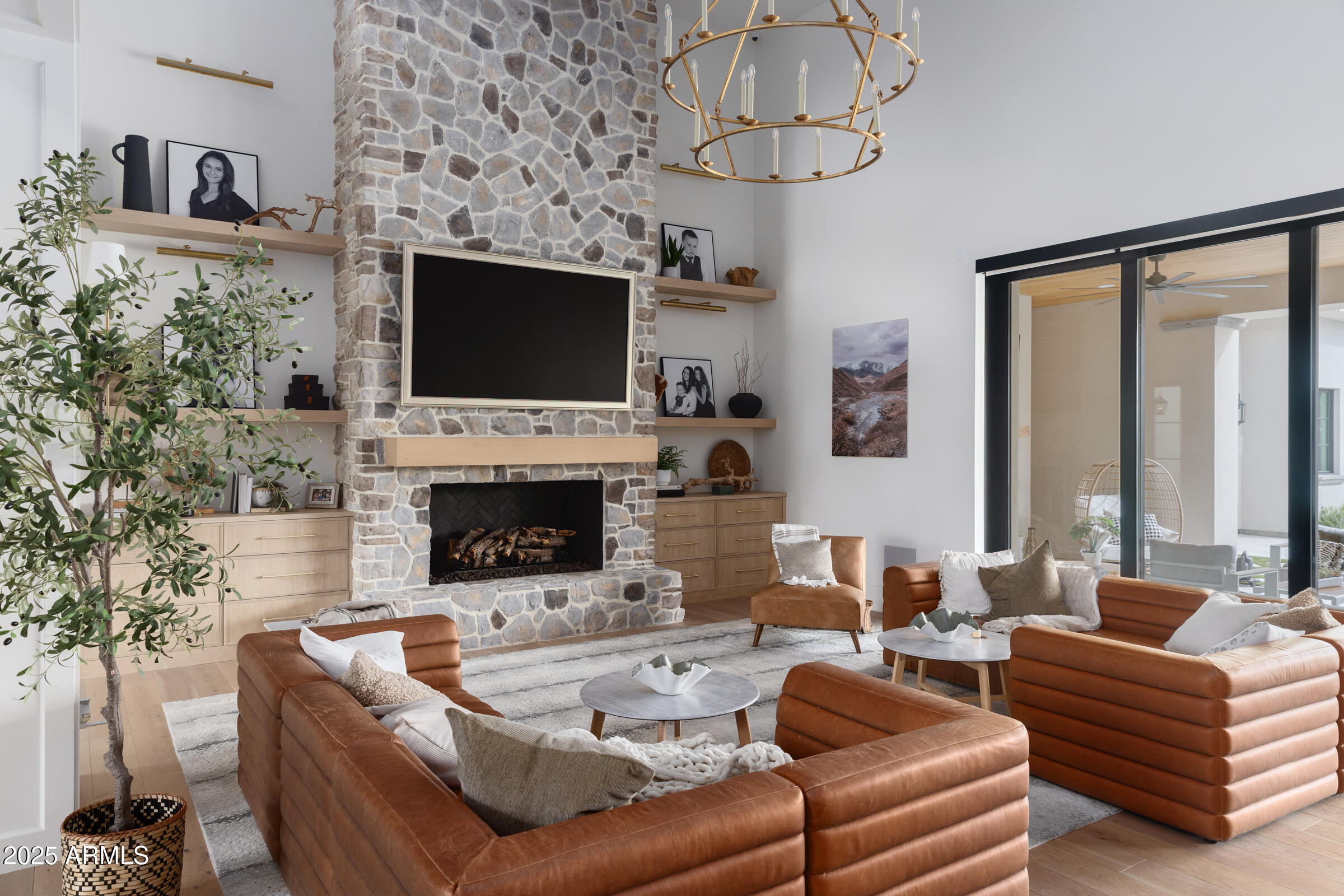 20623 East Cloud Road Queen Creek, AZ 85142 - Photo 11 of 115 a living room with furniture a flat screen tv and a fireplace