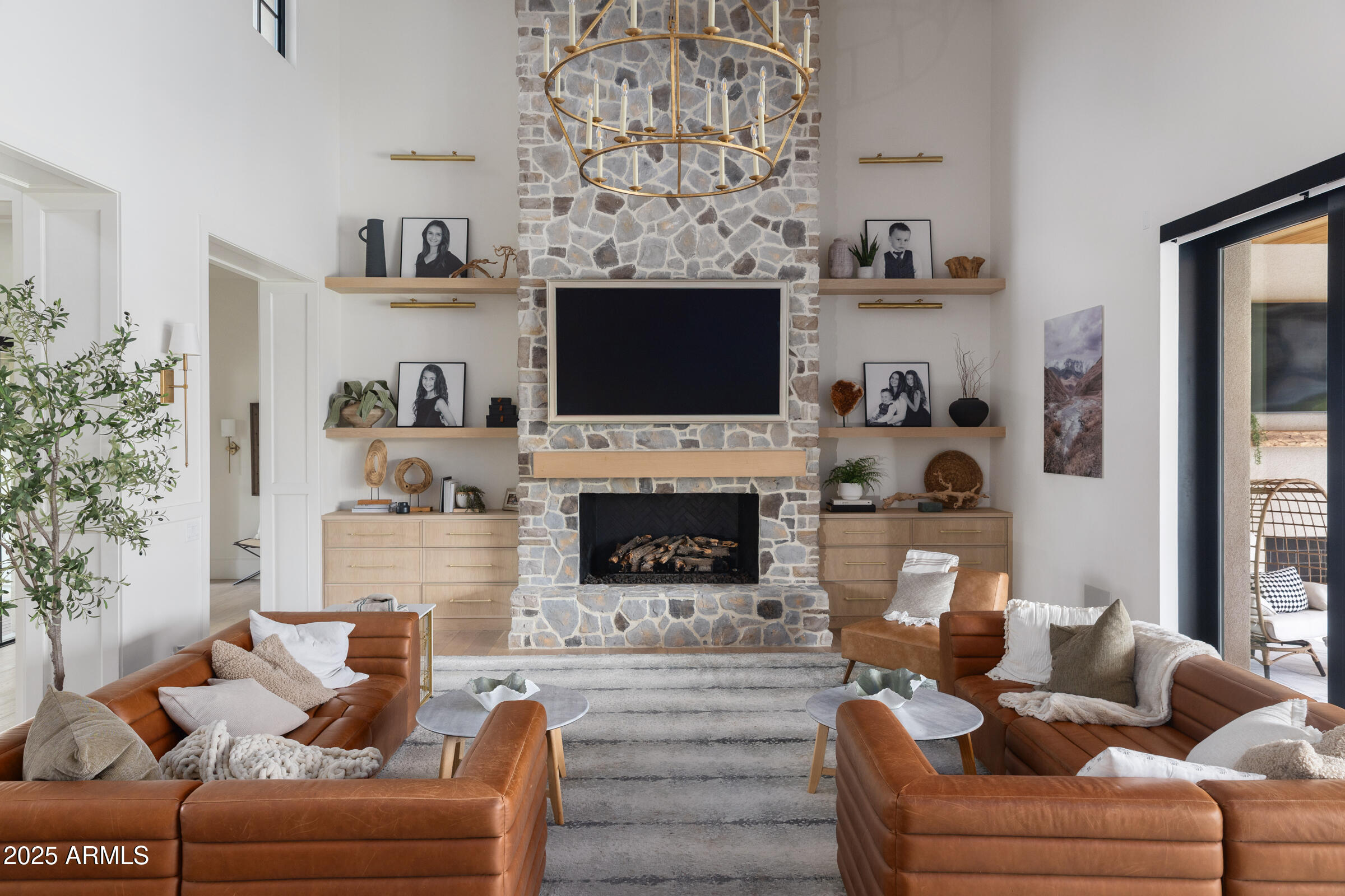 20623 East Cloud Road Queen Creek, AZ 85142 - Photo 13 of 115 a living room with furniture a flat screen tv and a fireplace