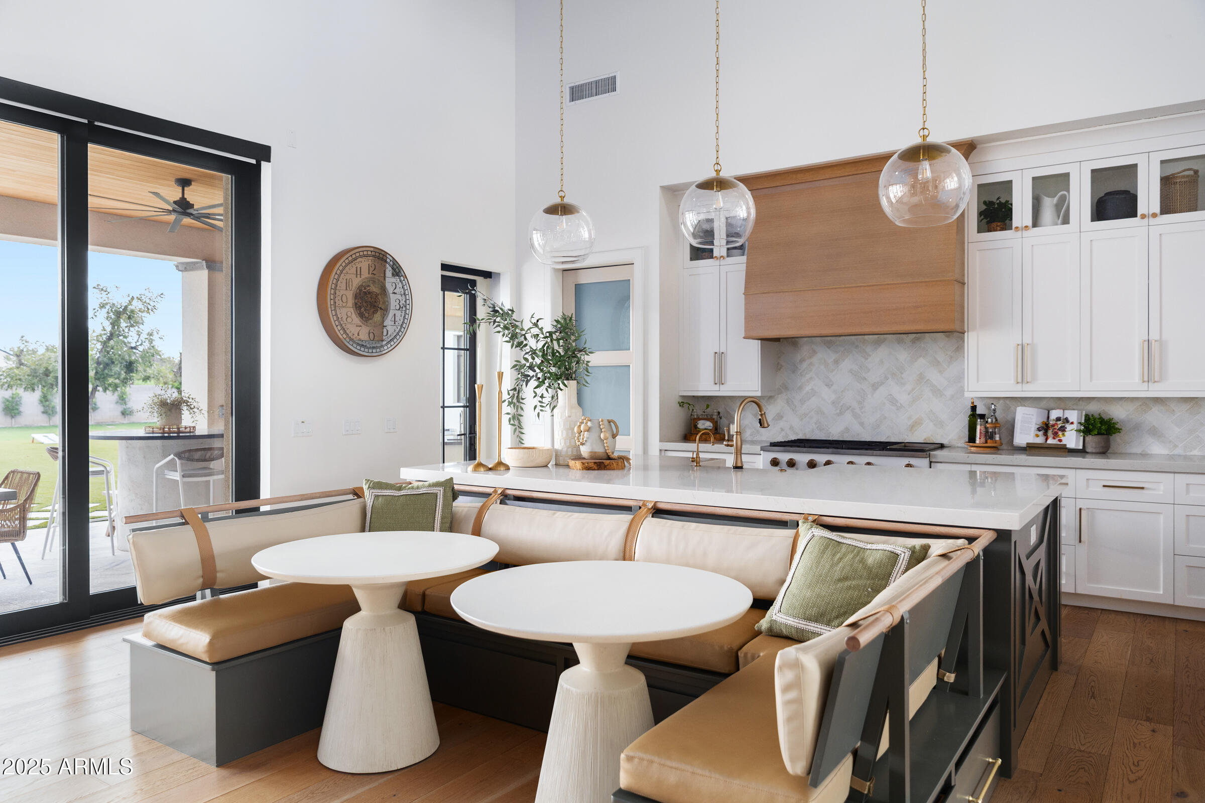 20623 East Cloud Road Queen Creek, AZ 85142 - Photo 16 of 115 a kitchen with a table chairs a stove a sink and a large window