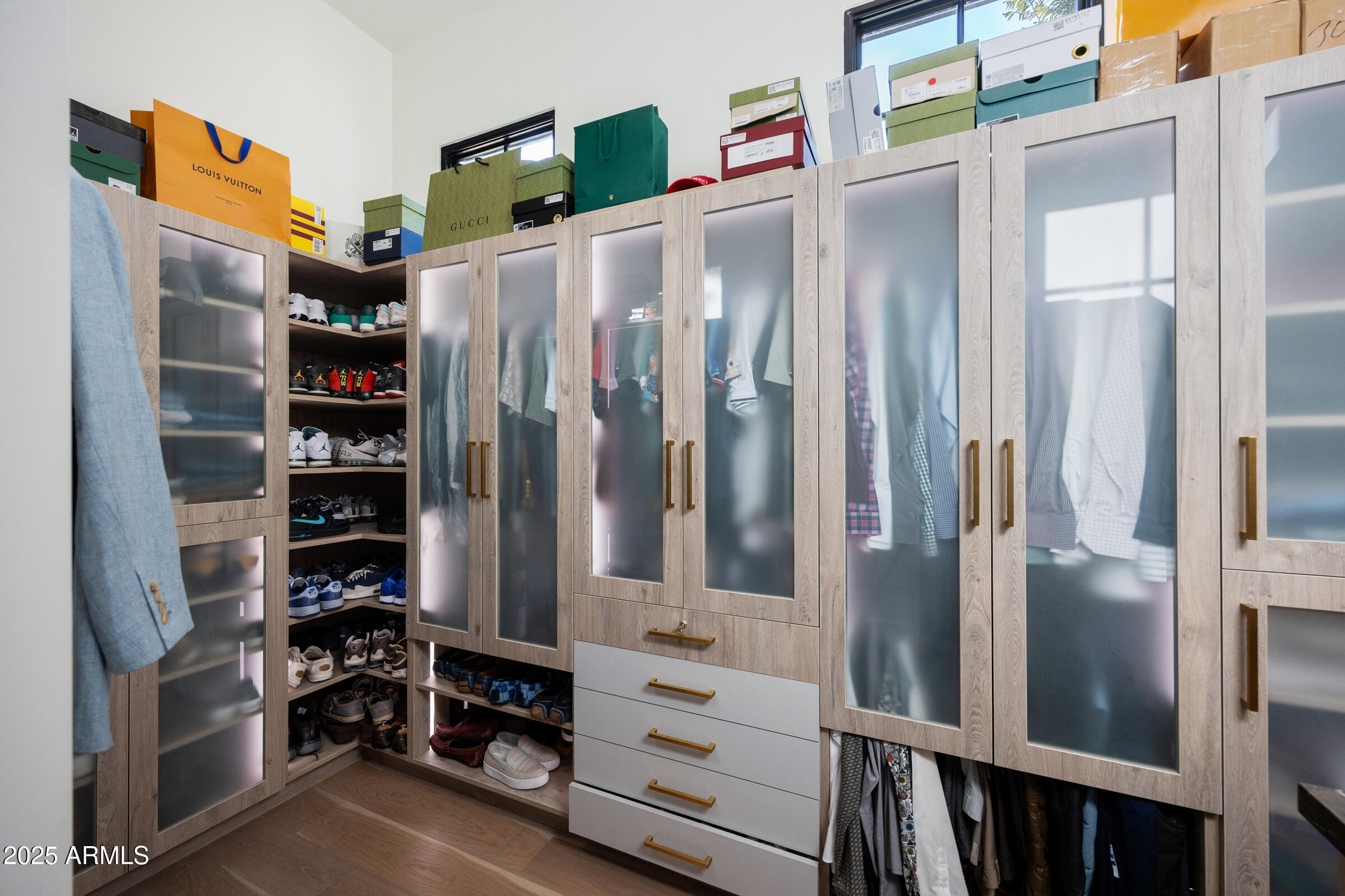 20623 East Cloud Road Queen Creek, AZ 85142 - Photo 42 of 115 a view of walk in closet with clothes and shoes
