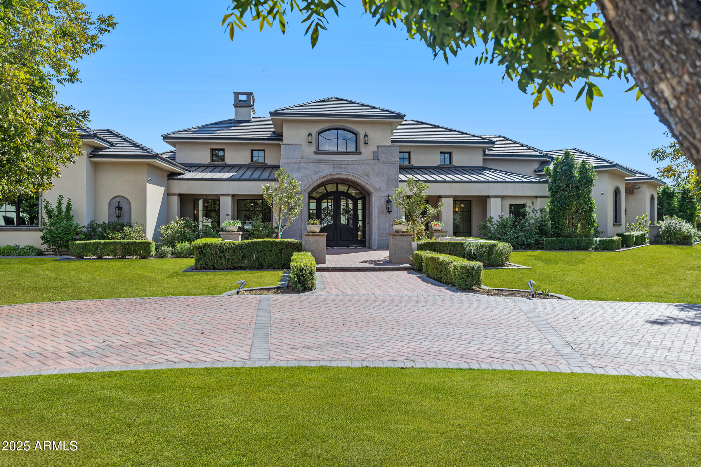 20623 East Cloud Road Queen Creek, AZ 85142 - Photo 6 of 115 a front view of a house with a garden and trees