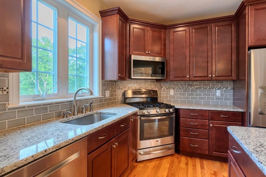 16 Mockingbird Hill Road Groton, MA 01450 - Photo 11 of 41 a kitchen with a sink stove top oven and cabinets