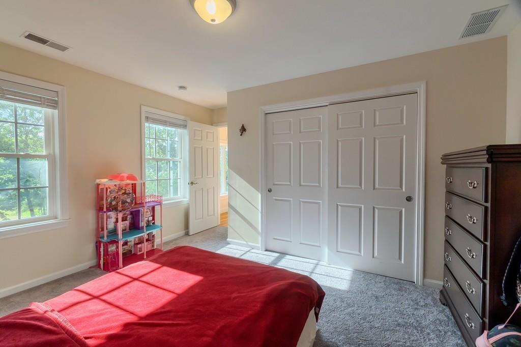 16 Mockingbird Hill Road Groton, MA 01450 - Photo 21 of 41 a bedroom with a bed closet and a flat tv screen