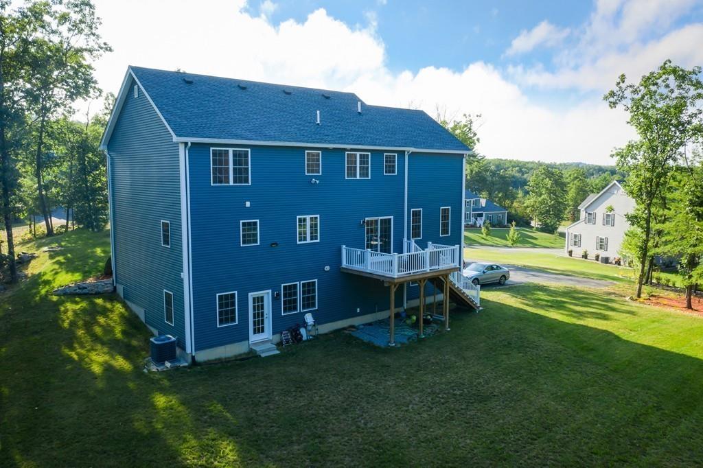16 Mockingbird Hill Road Groton, MA 01450 - Photo 33 of 41 a view of a house with a yard porch and sitting area