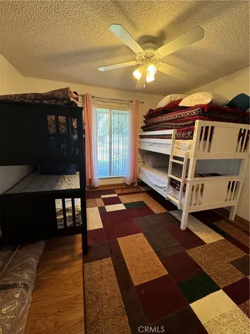 a backyard of a house with barbeque oven table and chairs