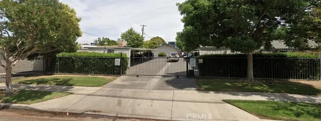 a view of a patio with table and chairs with wooden fence and plants