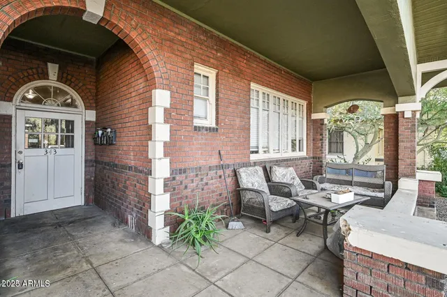 a front view of a house with outdoor seating