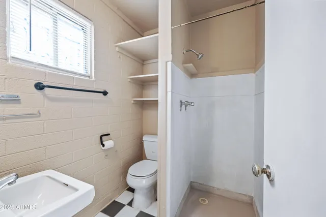 a bathroom with a toilet a sink and bath tub