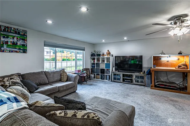 a kitchen with stainless steel appliances granite countertop a refrigerator a stove a sink and a microwave